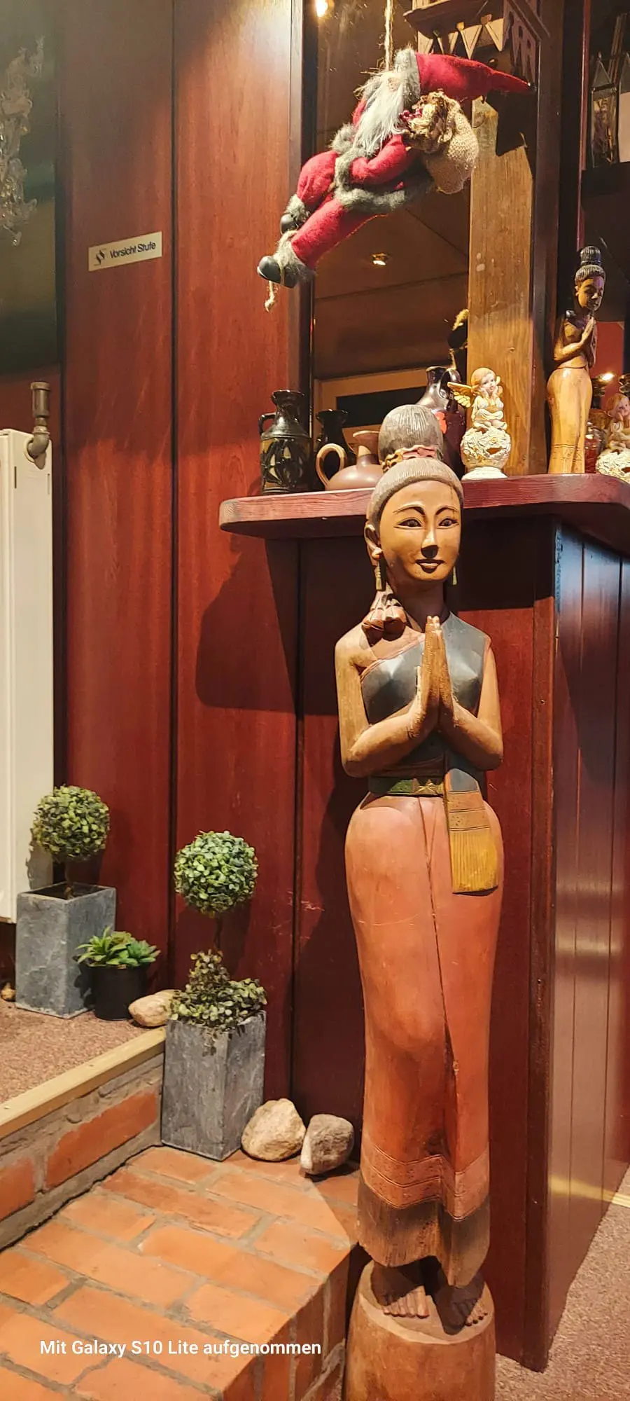 Carved wooden figure at the entrance