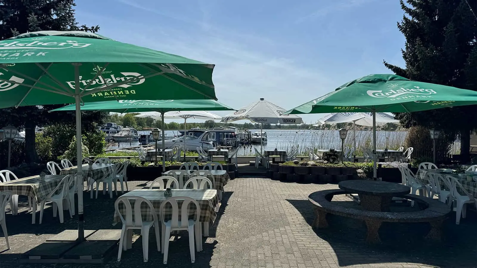 Seating under green parasols looking out over the water
